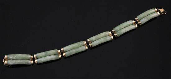 A Chinese 14ct gold mounted jade bracelet, 7in.